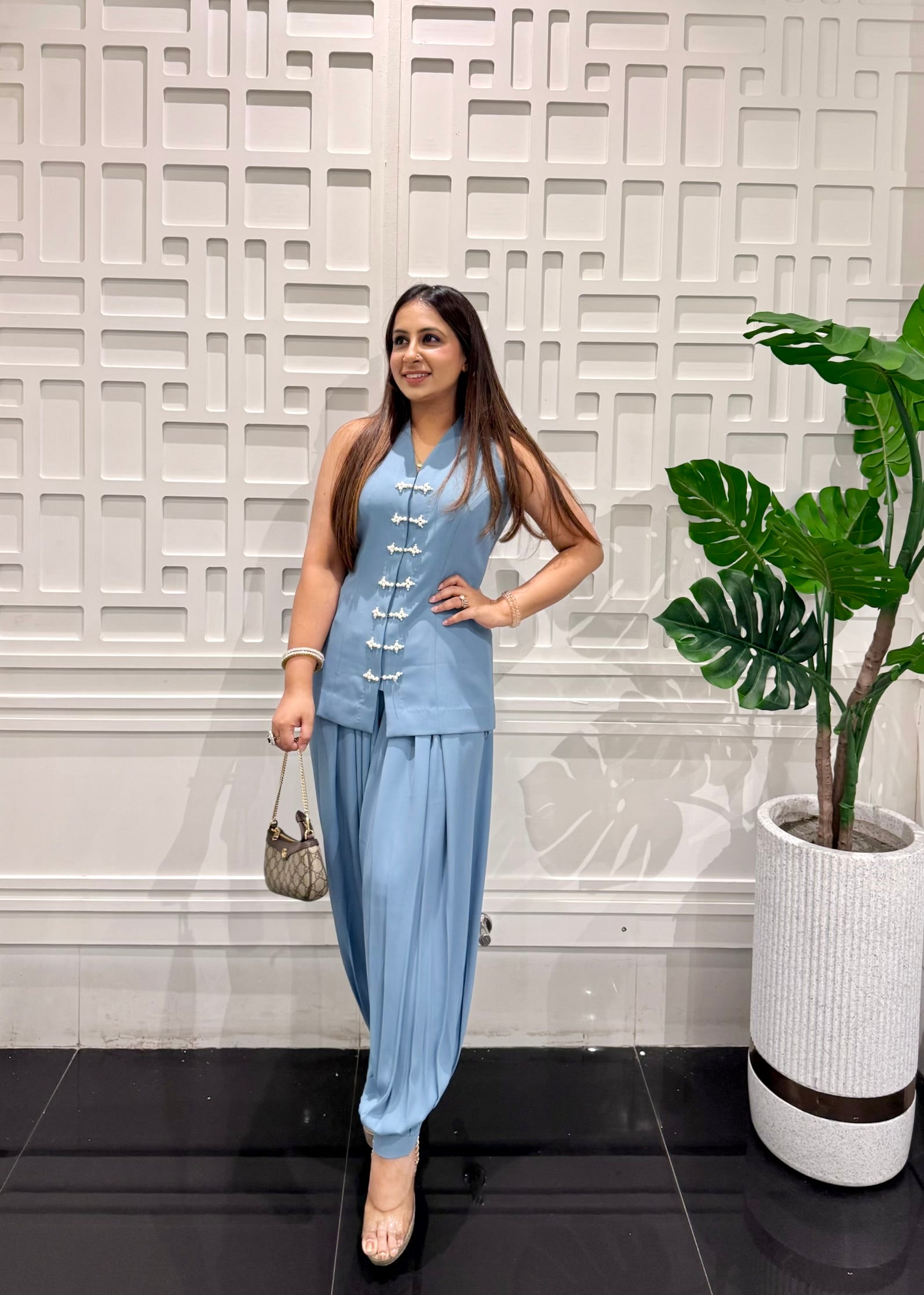 Bhawika Sachdeva model wears the Powder Blue Pearl Button Balloon Pants Co-ord Set in French crepe — sleeveless mandarin vest with pearl buttons and draped balloon pants, front angle