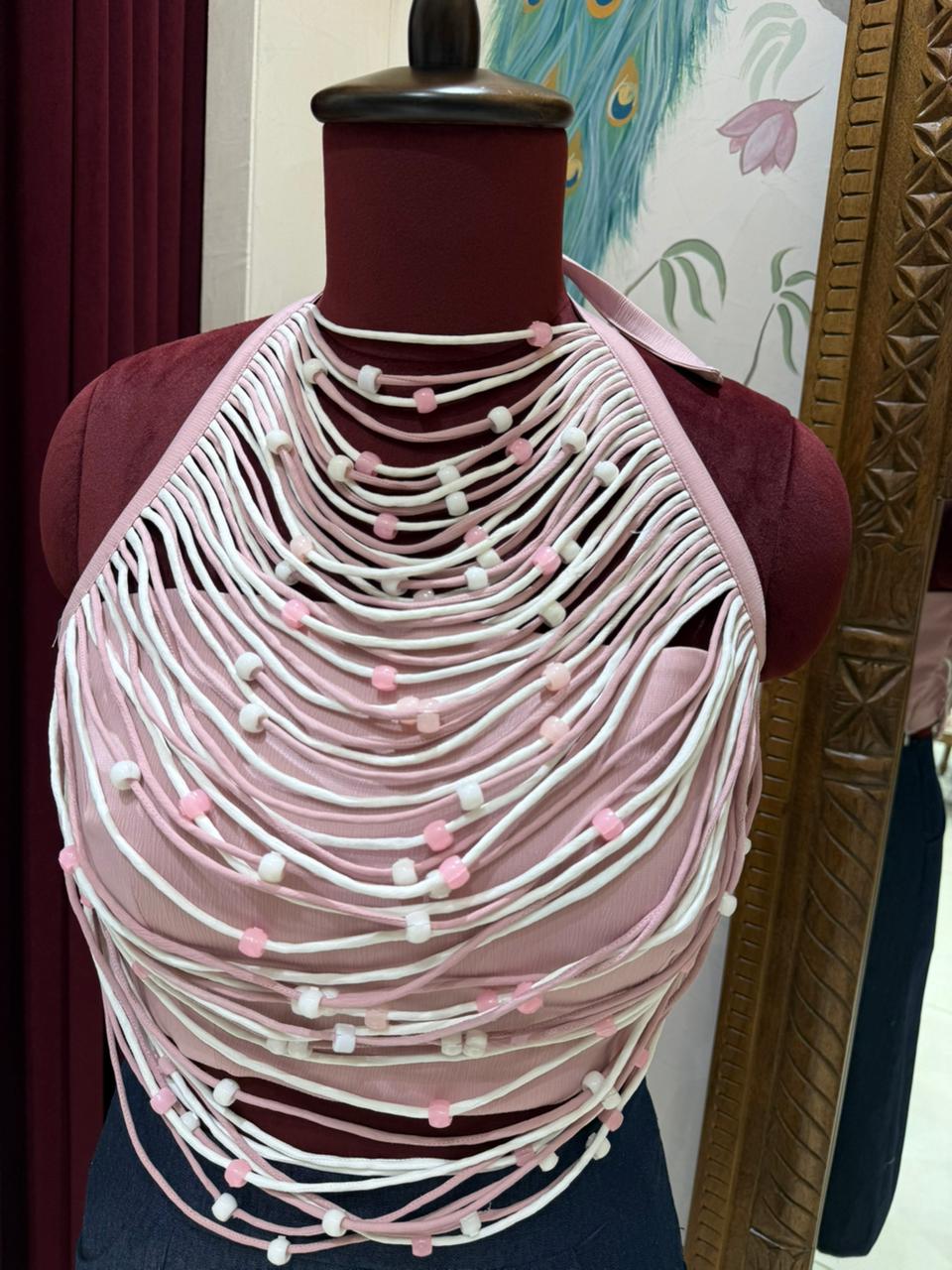 Model wearing pink French satin halter top with beaded fringe and matching mini skirt